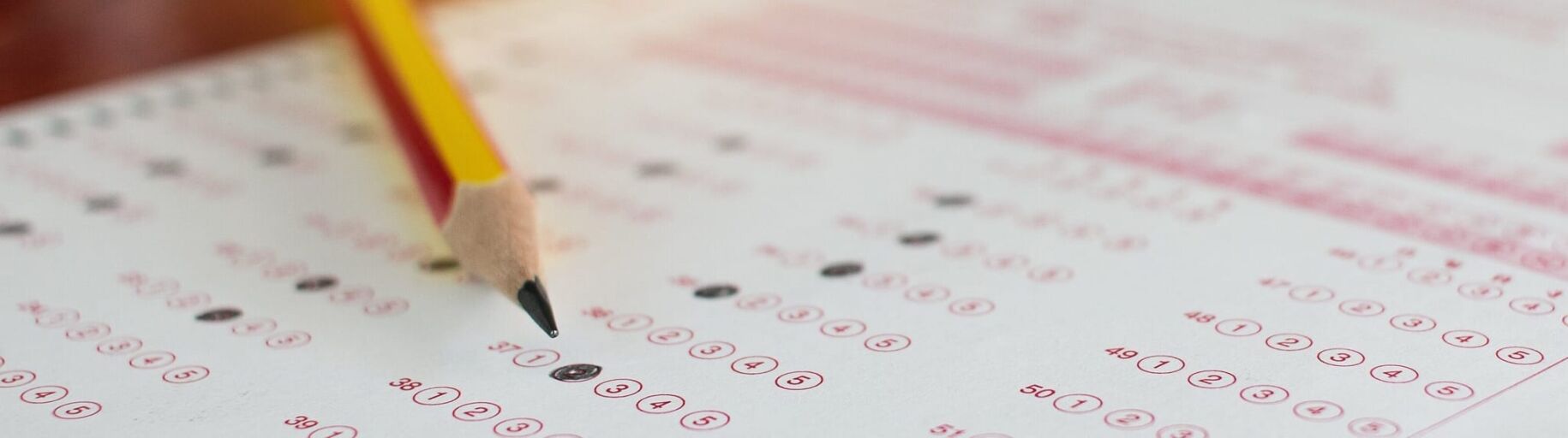 Standardized test answer sheet with pencil, representing college preparation.