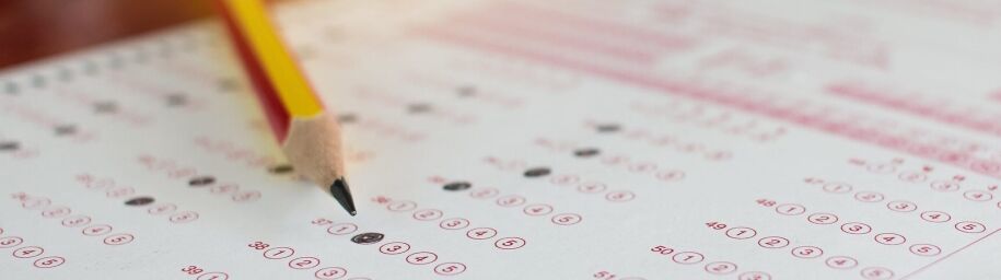 Standardized test answer sheet with pencil, representing college preparation.