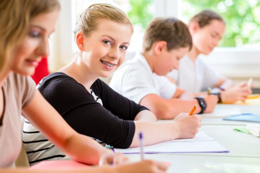 Students in a classroom setting, focused on their schoolwork.