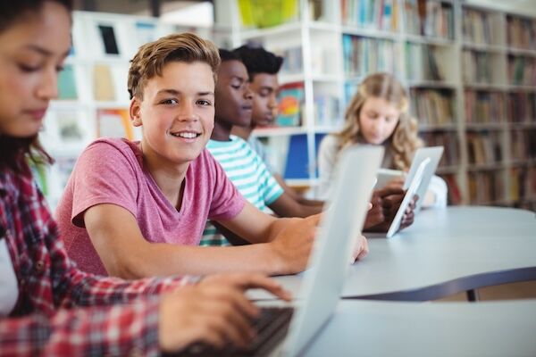 Students using laptops in a library