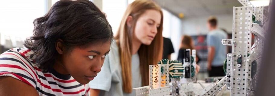 Students collaborate on a robotics project, showcasing STEM learning and teamwork.