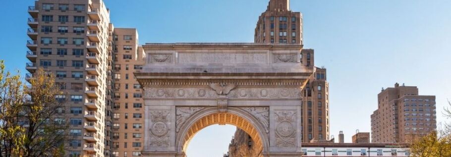 The Washington Square Arch on the NYU campus with part of the New York City skyline in the background