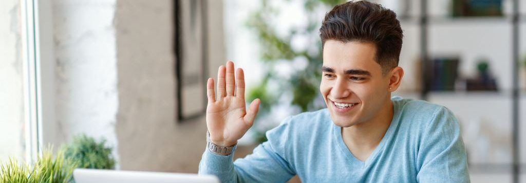 Student waves during a virtual college counseling session.