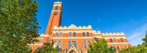 Campus building with clock tower against a clear blue sky.