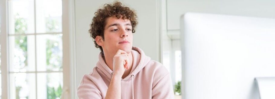 student checking his waitlist status on the computer