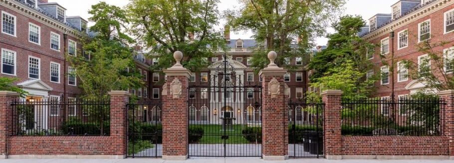 Ivy League campus architecture with brick buildings and wrought iron gates.