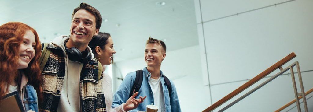 Smiling students walk on campus, representing college preparation and academic success.