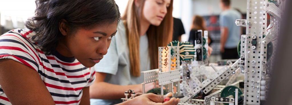 Students collaborate on a robotics project, showcasing STEM learning and teamwork.
