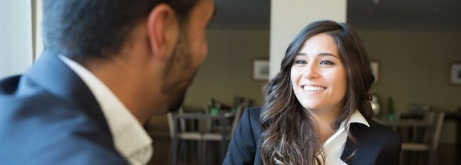 College counselor smiles during a meeting with a prospective student.