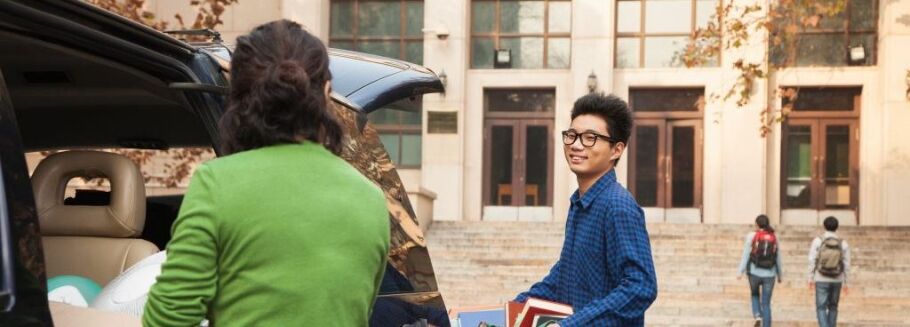 College student moving into dorm with family on campus.