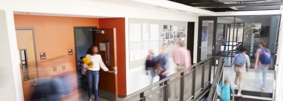 Students walking in a busy school hallway, representing the college application journey.