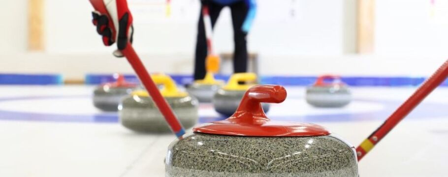 Curling stones on ice, teamwork and strategy for academic success.