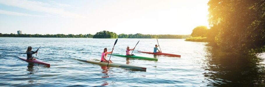 Students kayaking on a lake, symbolizing focus and drive toward college goals.