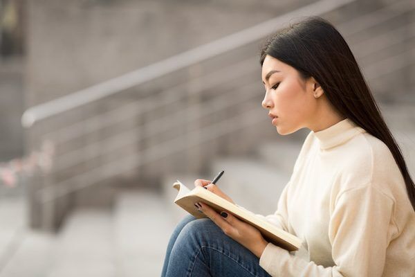girl student writing down educational goals