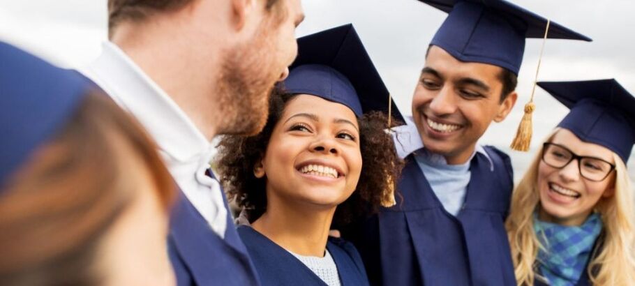 Happy graduates in caps and gowns celebrate their academic success together.