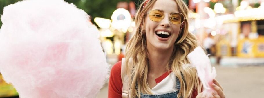 Happy student with cotton candy celebrates college acceptance.