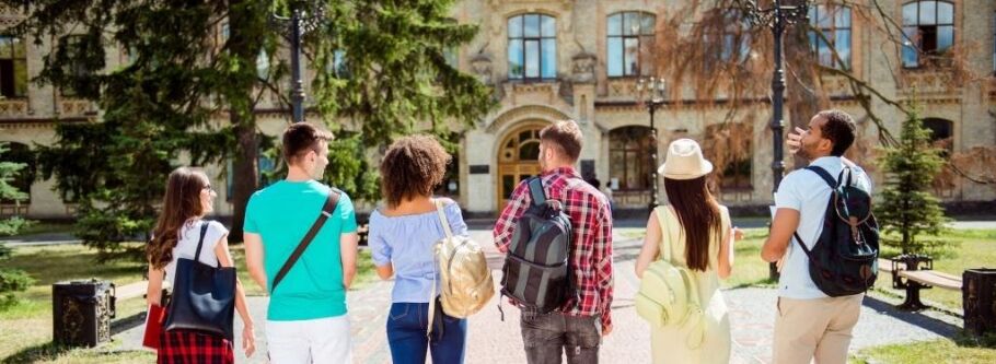 College students walk towards a campus building, ready to learn and succeed.