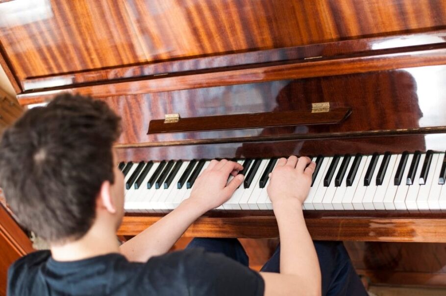 Student plays piano, showcasing extracurricular activities for college applications.