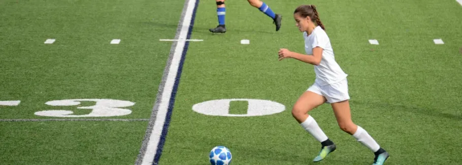 Student athlete playing soccer, demonstrating extracurricular activities for college applications.