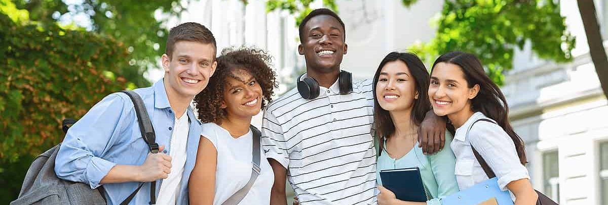 Smiling diverse students on campus, ready for college success with IvyWise.