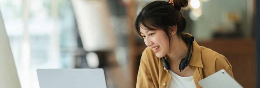 Student views IvyWise website on laptop and phone for college application help.