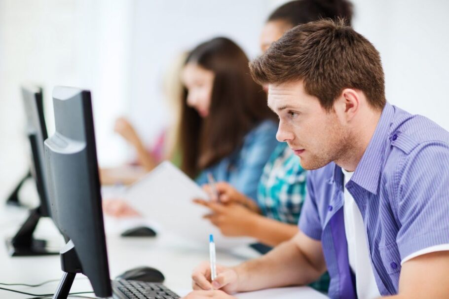 Students working on computers, possibly preparing college applications or studying.