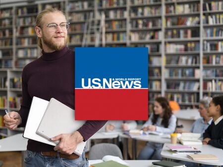 U.S. News logo over a graduate student in a library.