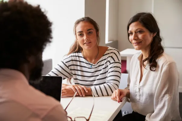 Student and parent meet with college counselor to discuss admissions strategy.