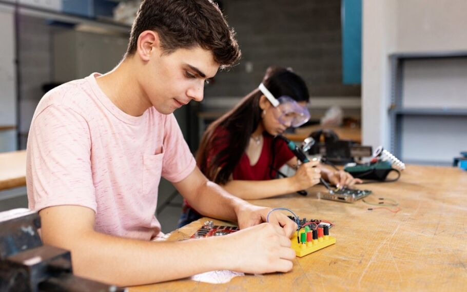 Students working on an electronics project, showcasing STEM learning opportunities.