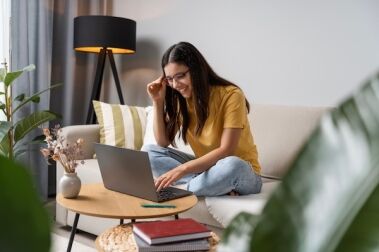 teenage girl writing on laptop