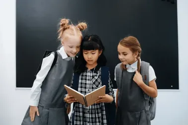 Students Looking at Book